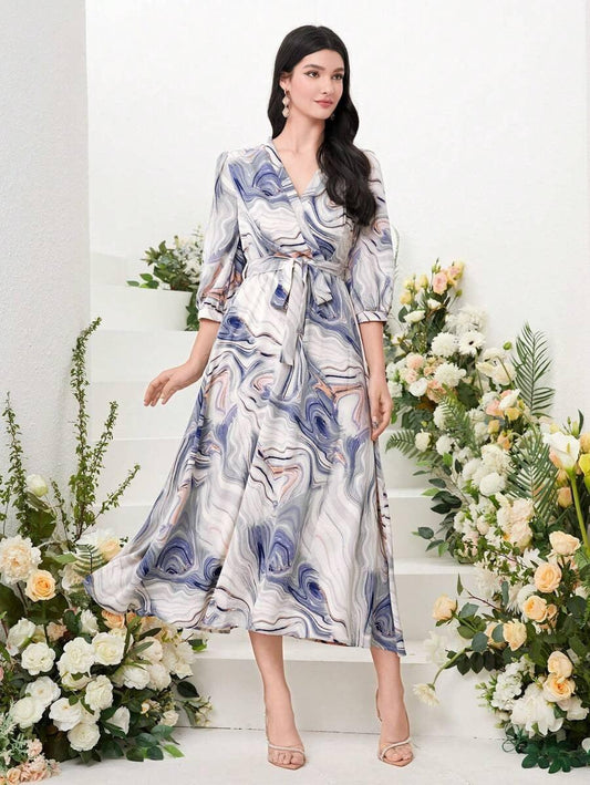 Burning Bones Marble Print Surplice Neck Belted Dress featuring elegant blue and white marble swirl pattern, three-quarter length sleeves, wrap-style V-neckline, midi length silhouette, and matching fabric belt against floral backdrop with white and yellow roses