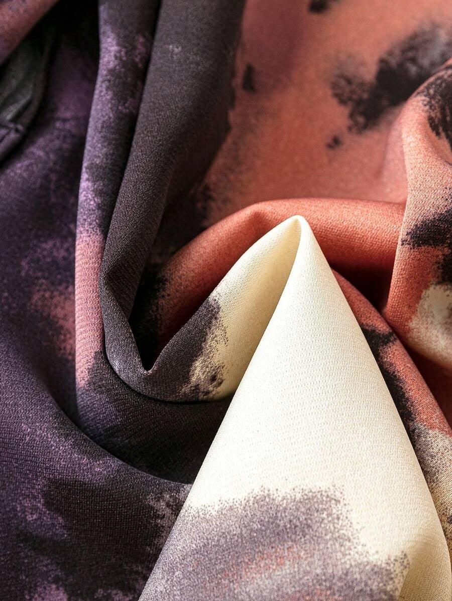 Burning Bones GEO PRINTED TANK MIDI DRESS fabric detail showing elegant draping with abstract geometric pattern in purple, coral, and cream tones. Close-up texture view of rayon material with soft folds highlighting the dress's unique print design.